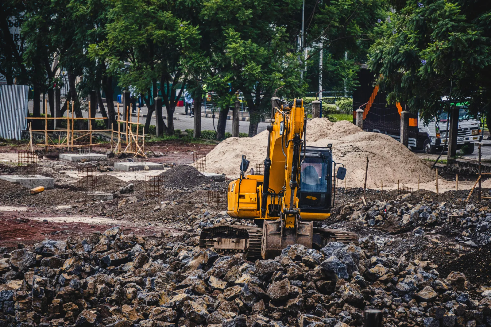 Excavator working across a mid-sized construction site.