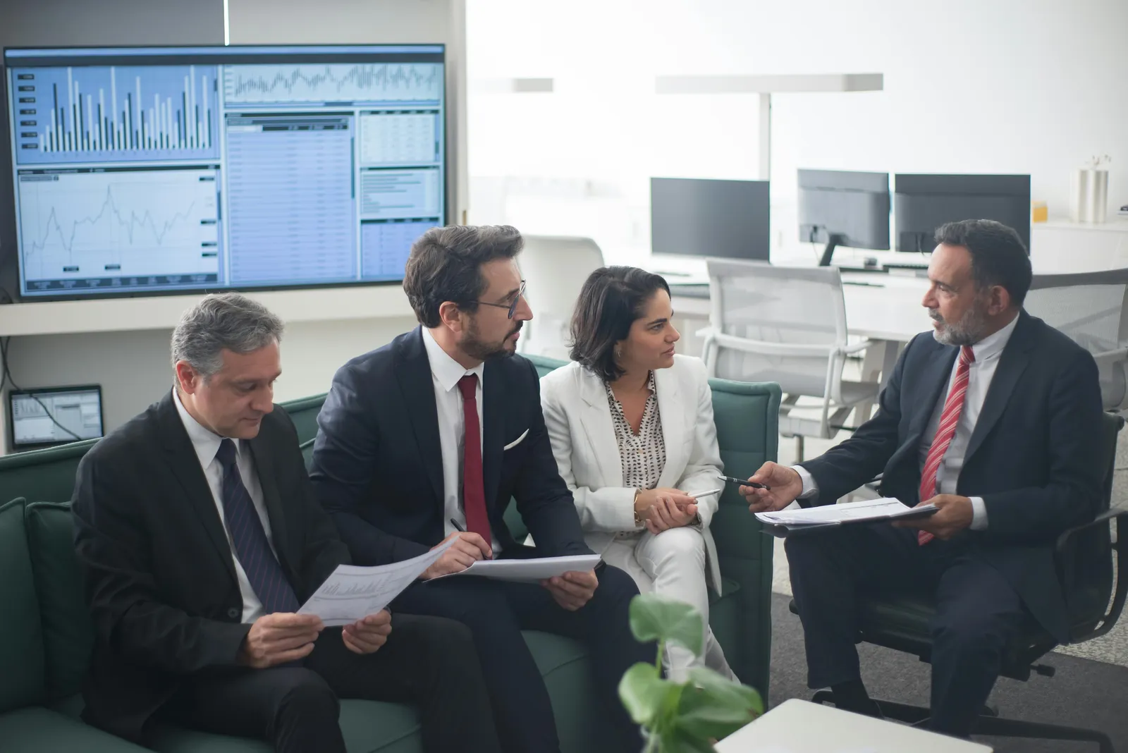 Executives reviewing charts and financial performance dashboards.